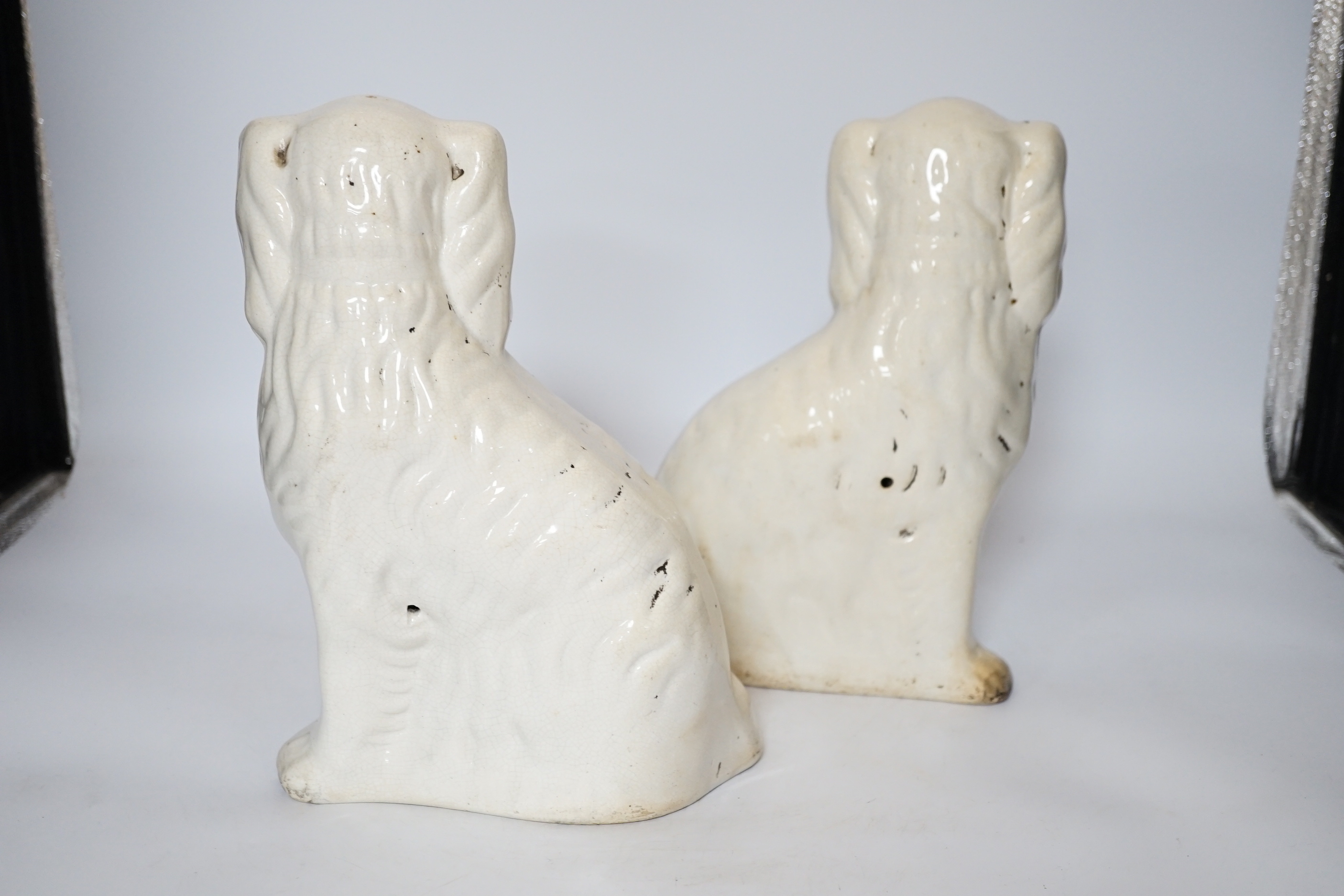 A pair of Staffordshire pottery dogs, 25cm high